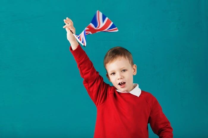 School boy waving flag
