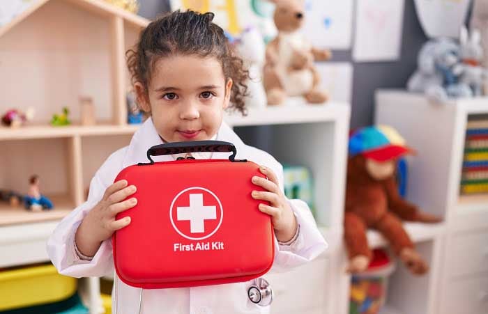 Pre school girl with first aid kit